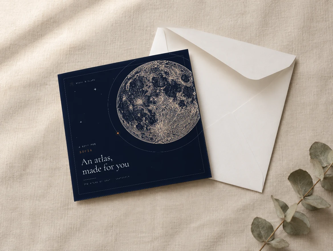 The printed gift card: the engraved moon from the cover and their name, beside its envelope