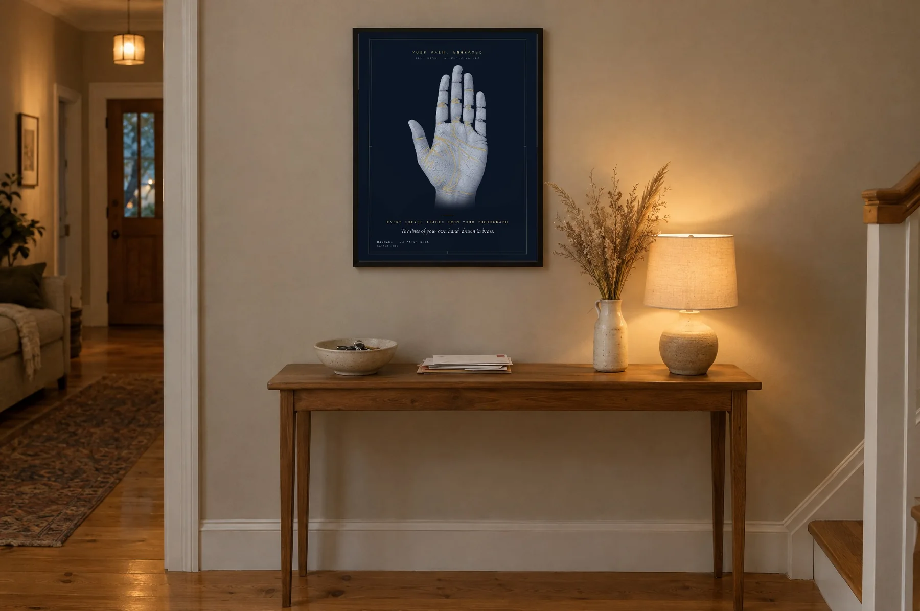 The palm print on navy paper above a hallway console table