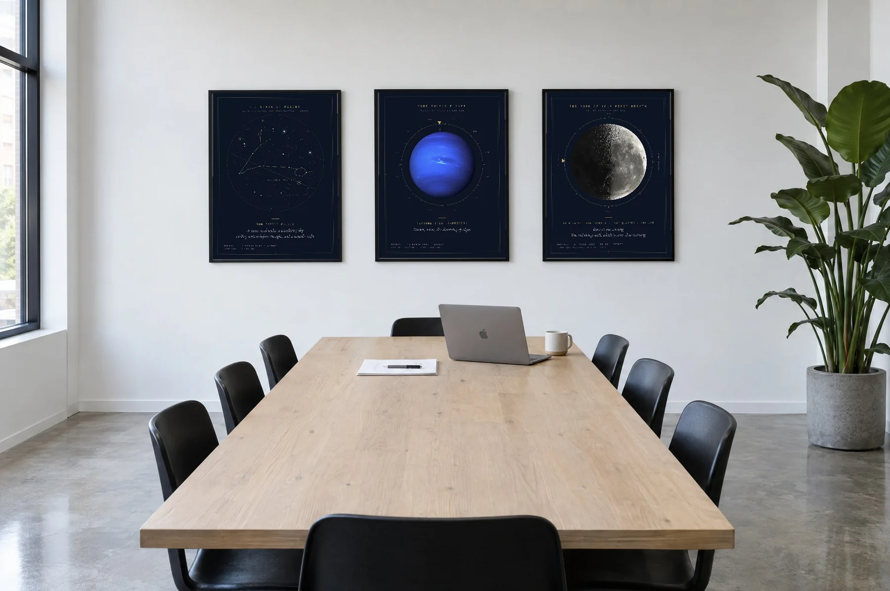 Three navy prints in black frames along the wall of an office meeting room